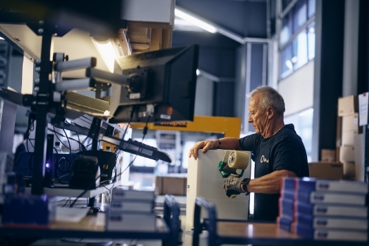 Mitarbeiter Logistik am Packtisch